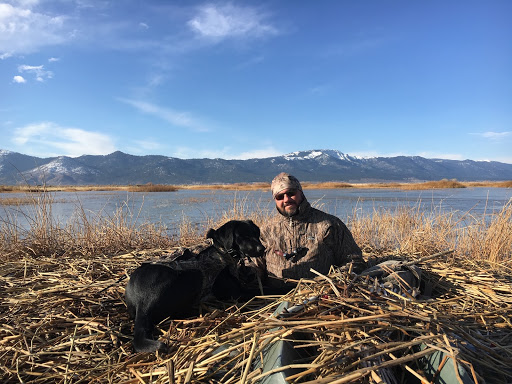man out hunting with his dog